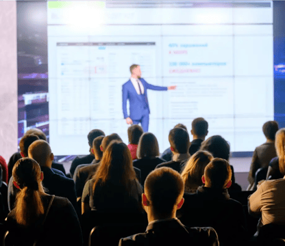 Looking from audience at man giving presentation