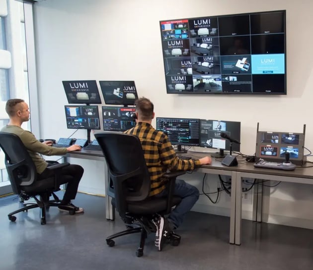 Two men working at multiple monitors